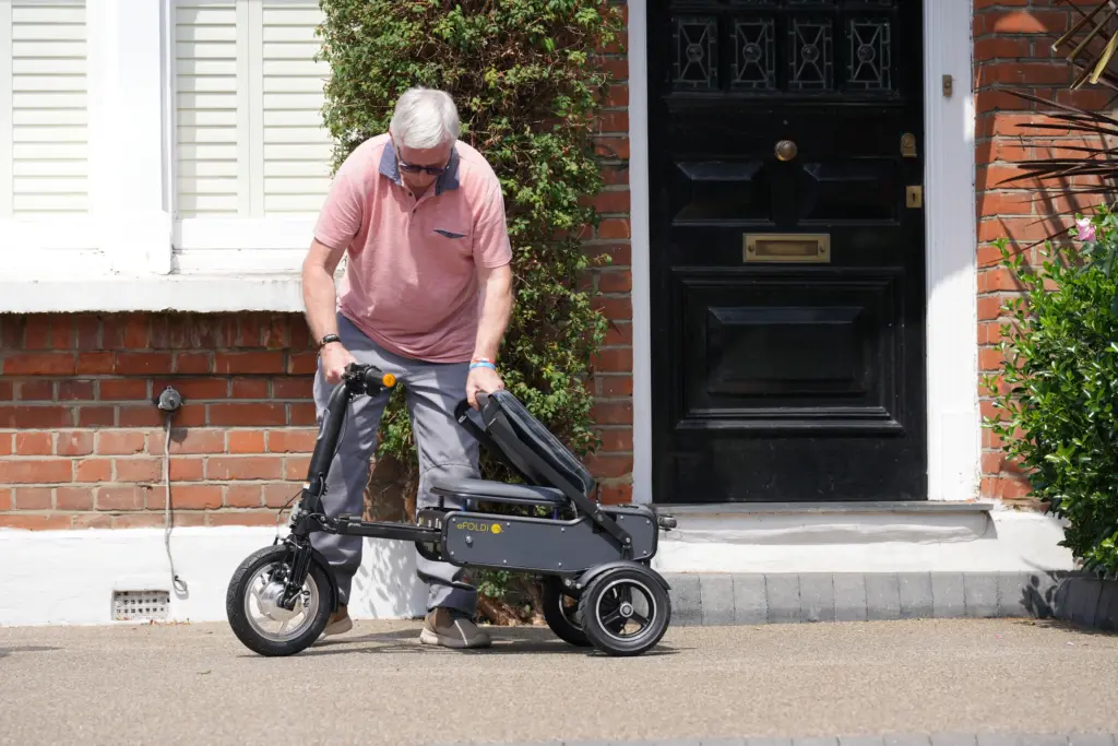 Man folding scooter
