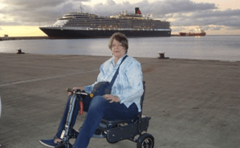 Maggie on her scooter at the beach